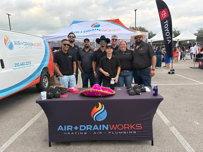 Air & Drain Works technician servicing an outdoor AC unit in San Antonio
